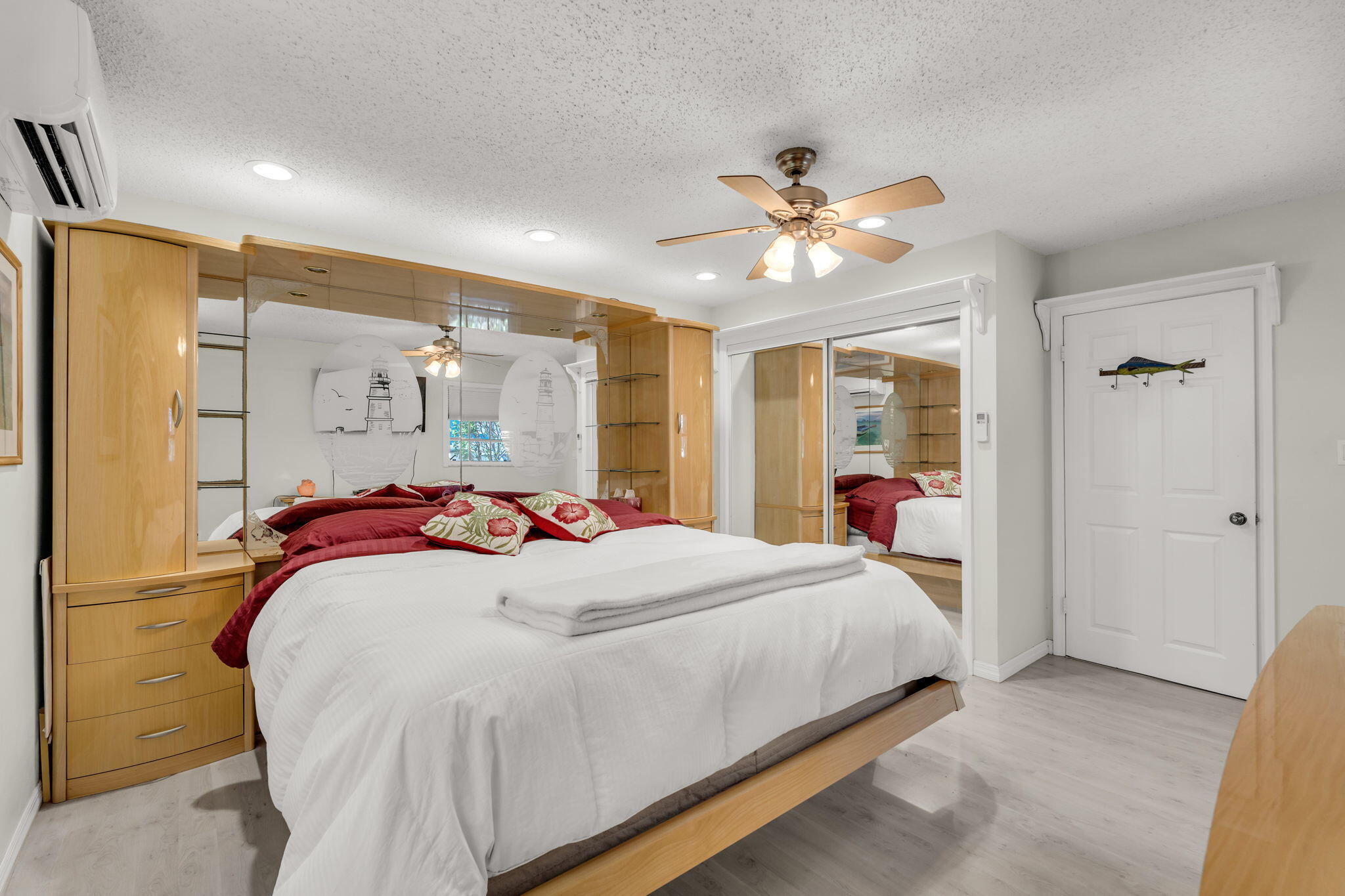 335 Sound Drive Key Largo, FL 33037 - Photo 18 of 45 a bedroom with a large bed and a chandelier