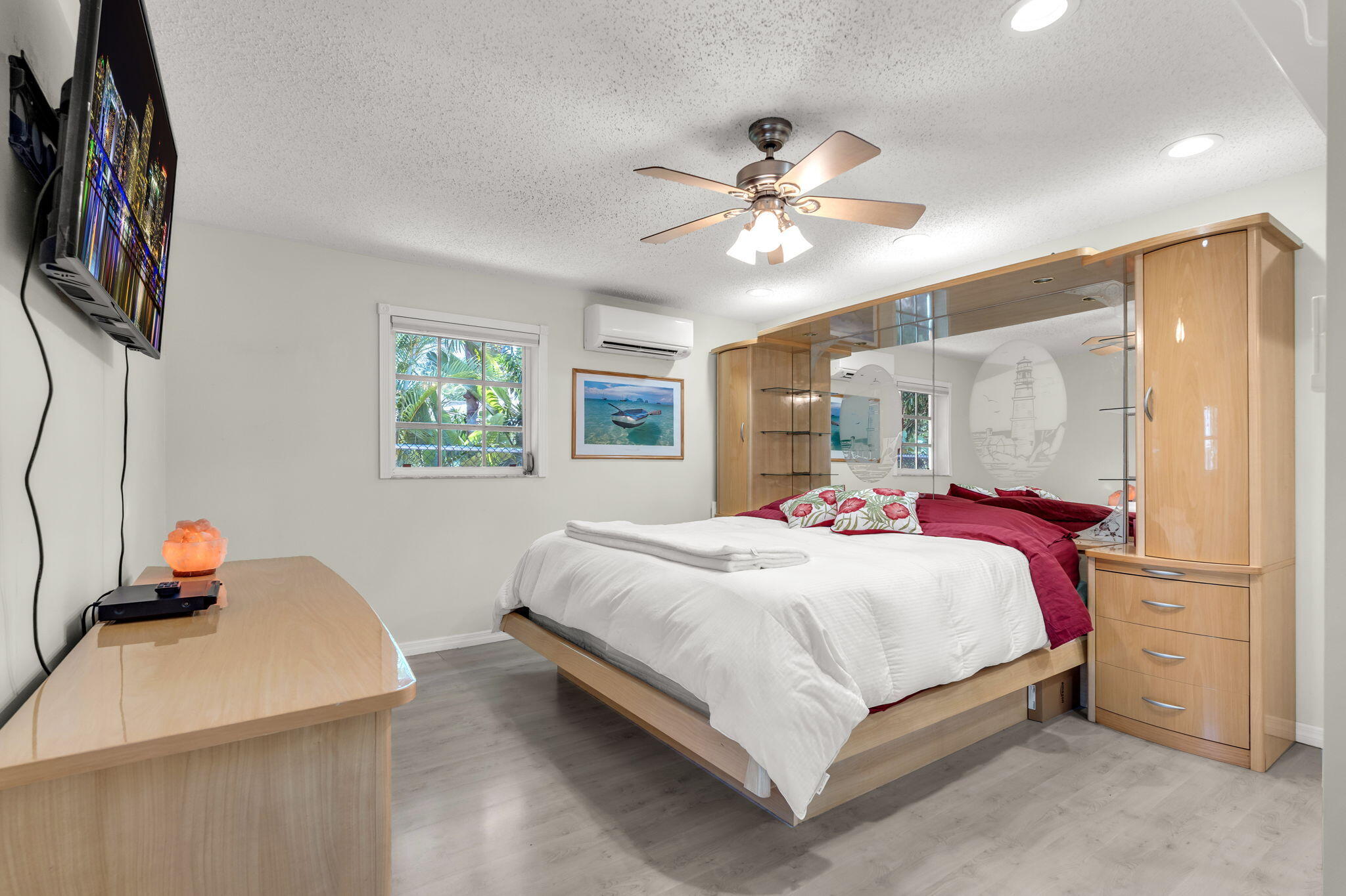 335 Sound Drive Key Largo, FL 33037 - Photo 19 of 45 a bedroom with a large bed and a chandelier