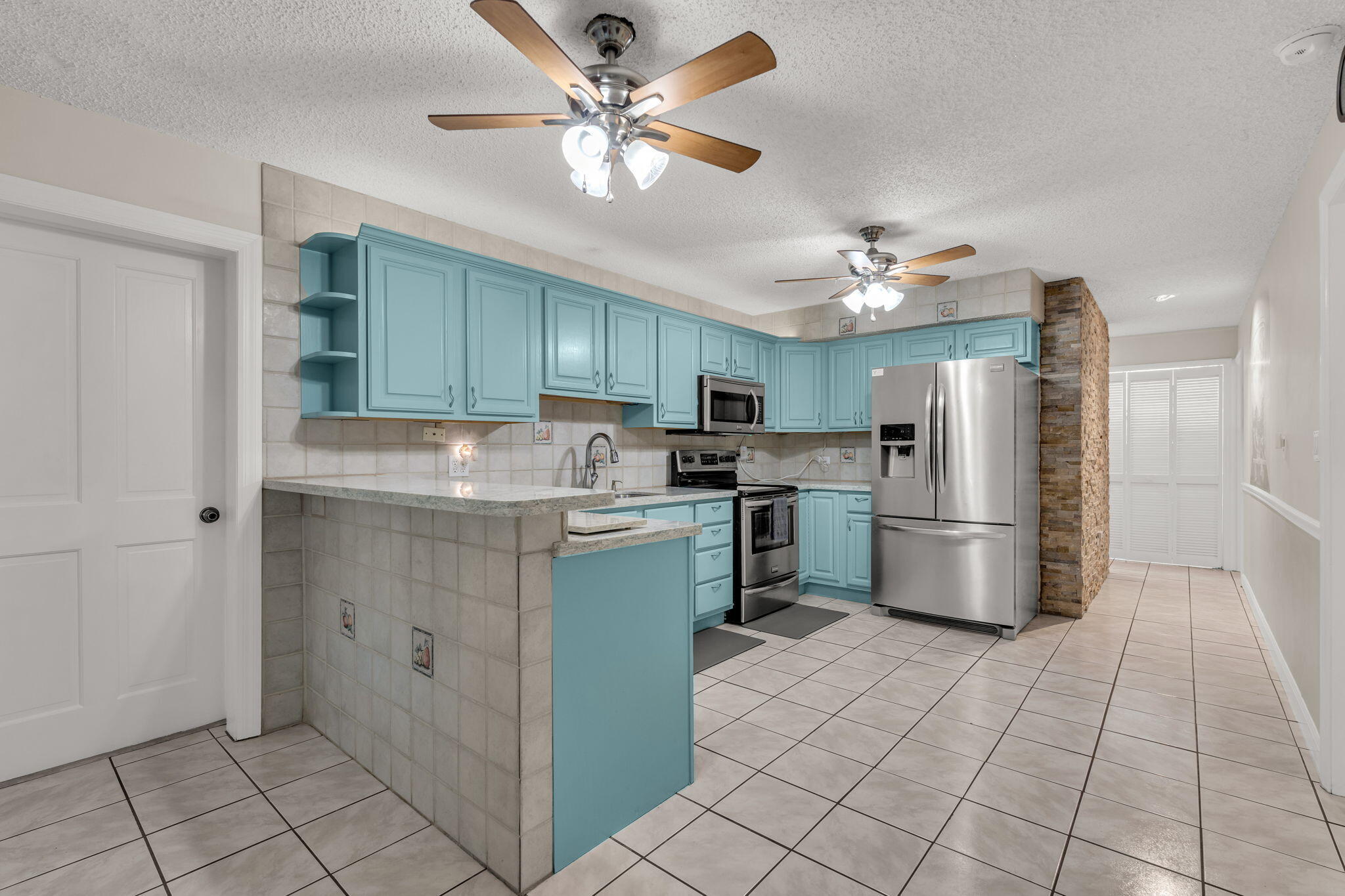 335 Sound Drive Key Largo, FL 33037 - Photo 2 of 45 a kitchen with kitchen island a refrigerator sink and cabinets