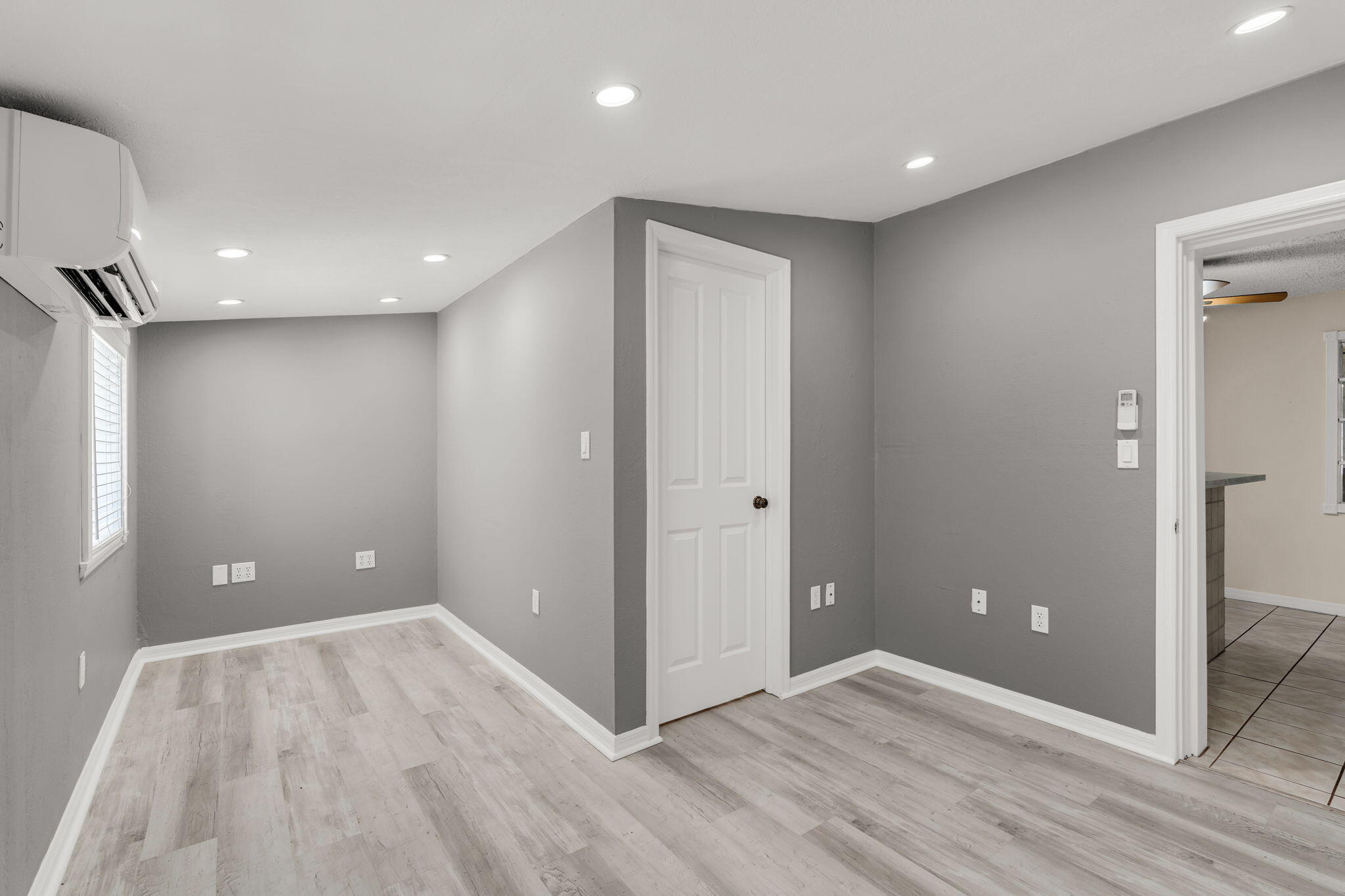 335 Sound Drive Key Largo, FL 33037 - Photo 25 of 45 a view of an empty room with wooden floor and a bathroom