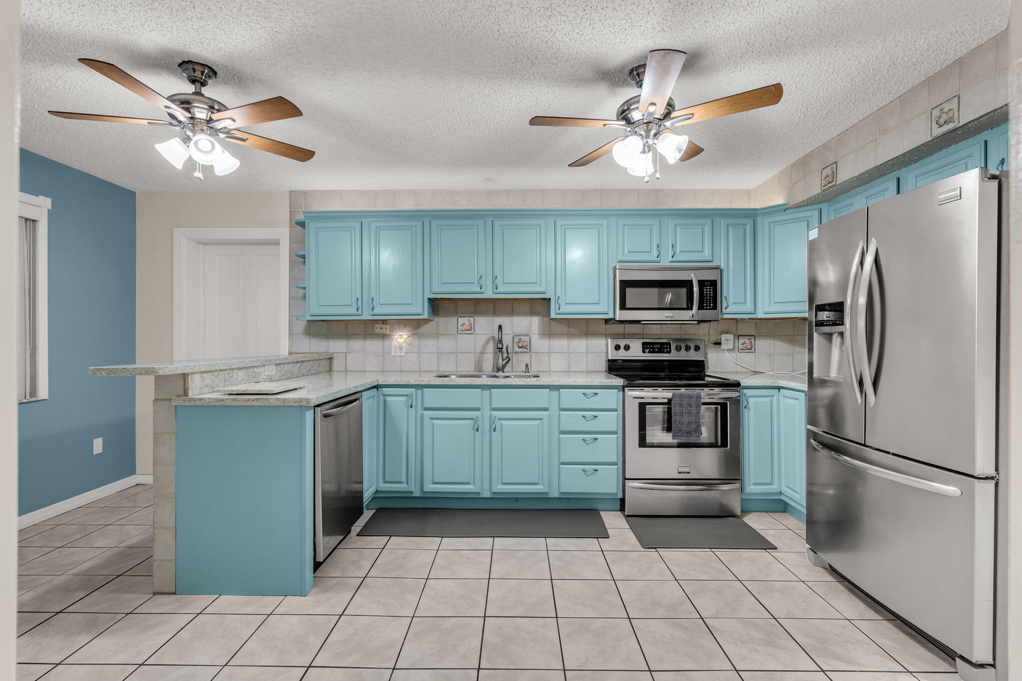 335 Sound Drive Key Largo, FL 33037 - Photo 10 of 45 a kitchen with a refrigerator a sink and dishwasher