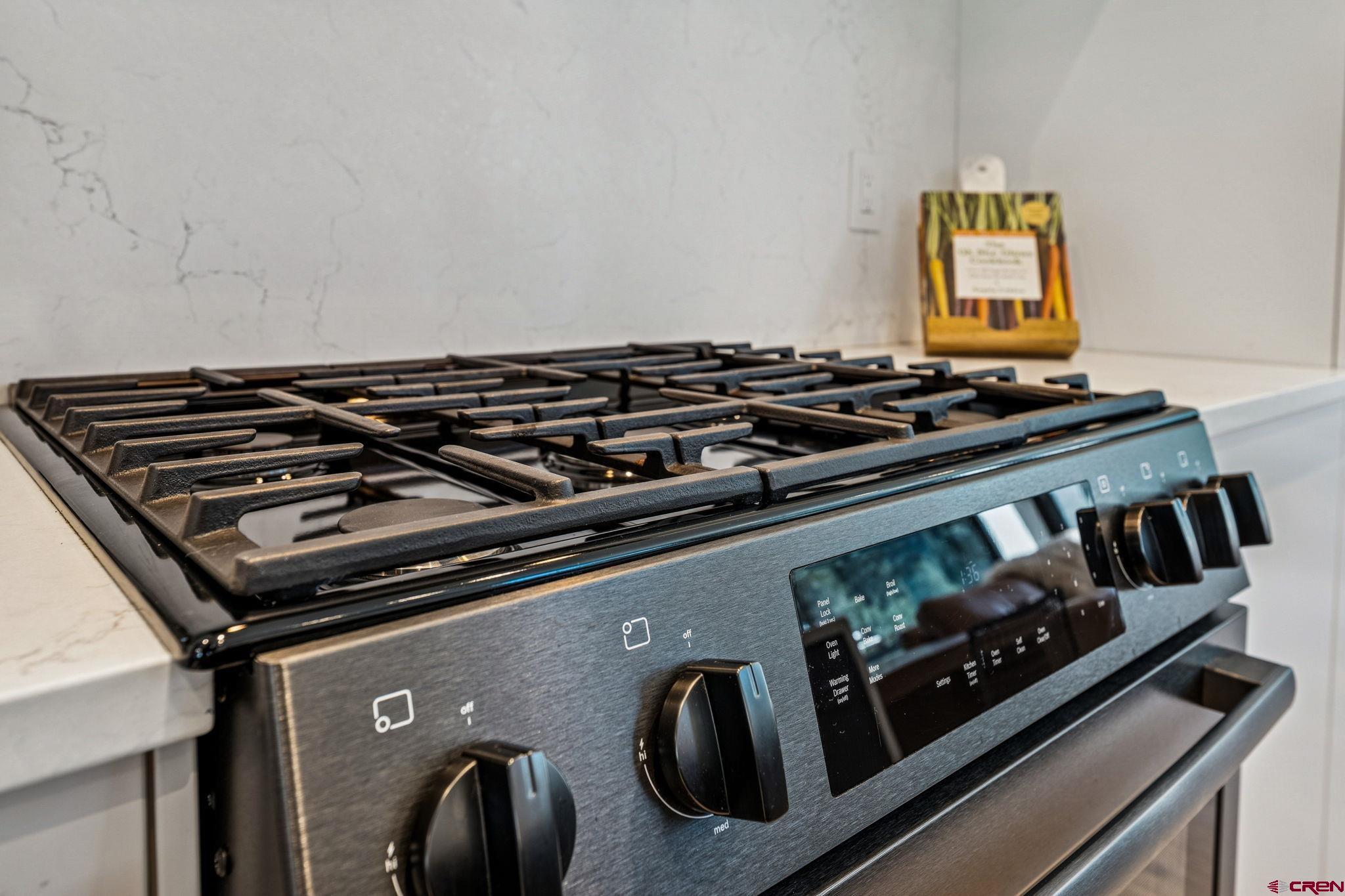 55 Bell Flower Court Durango, CO 81301 - Photo 10 of 44 a close up of a stove sitting inside of a kitchen