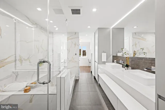 a bathroom with a tub sink and mirror