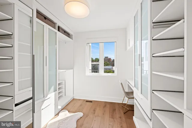 a view of room with window and wooden floor
