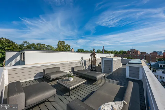 a view of a terrace with couches and lounge chairs