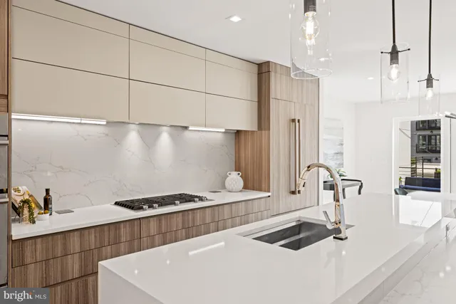 a kitchen with a sink a stove and a refrigerator