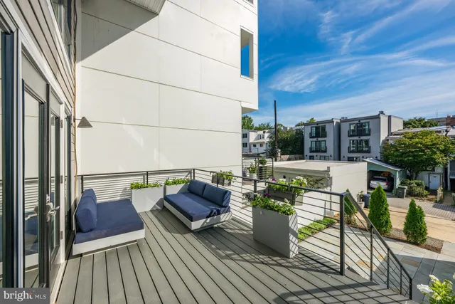 a view of balcony with chairs and wooden floor