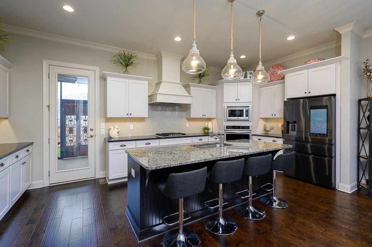 472 River Bluff Drive Franklin, TN 37064 - Photo 11 of 34 a kitchen with stainless steel appliances a dining table chairs stove refrigerator and cabinets