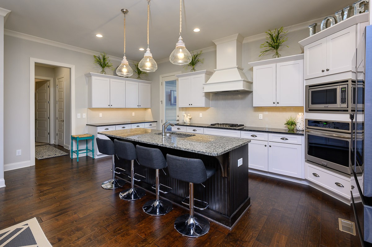 472 River Bluff Drive Franklin, TN 37064 - Photo 10 of 34 a kitchen with granite countertop a stove a sink and a refrigerator
