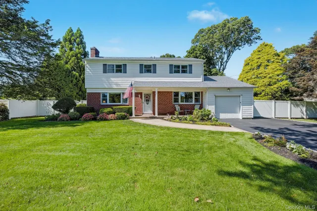 a view of a house with a yard patio and swimming pool