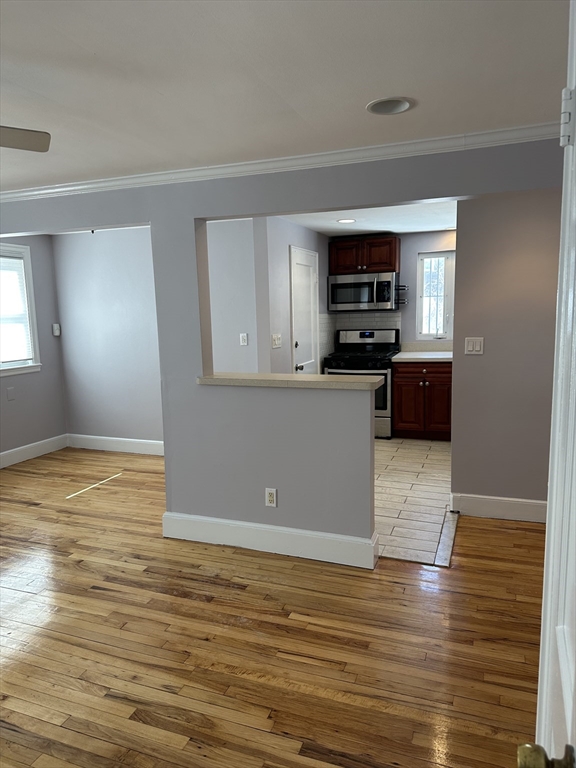 33 Paragon Road Boston, MA 02132 - Photo 4 of 8 a view of kitchen and empty room with wooden floor