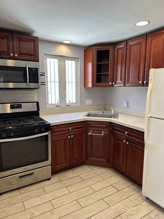 33 Paragon Road Boston, MA 02132 - Photo 5 of 8 a kitchen with stainless steel appliances granite countertop a stove microwave and sink