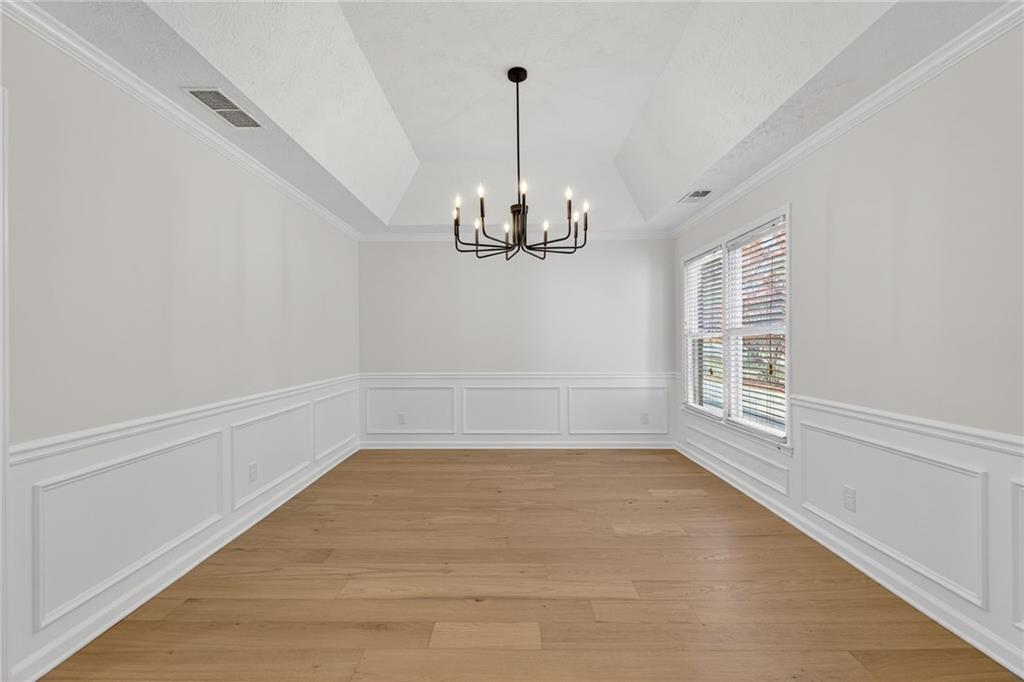 601 Cobblestone Lane Stone Mountain, GA 30087 - Photo 14 of 69 a view of a room with window wooden floor and chandelier
