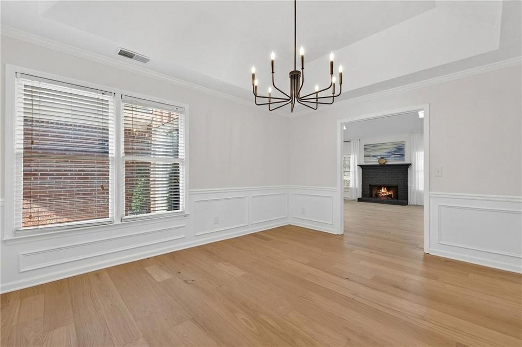 601 Cobblestone Lane Stone Mountain, GA 30087 - Photo 16 of 69 a view of an empty room with wooden floor fireplace and a window
