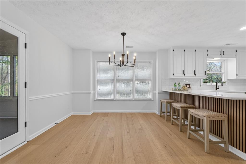 601 Cobblestone Lane Stone Mountain, GA 30087 - Photo 17 of 69 an empty room with wooden floor and windows