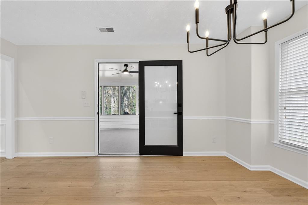 601 Cobblestone Lane Stone Mountain, GA 30087 - Photo 18 of 69 a view of an empty room with wooden floor and a window