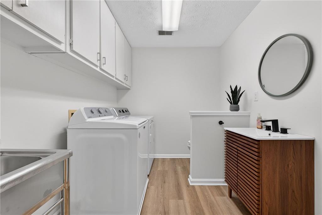 601 Cobblestone Lane Stone Mountain, GA 30087 - Photo 25 of 69 a utility room with sink dryer and washer