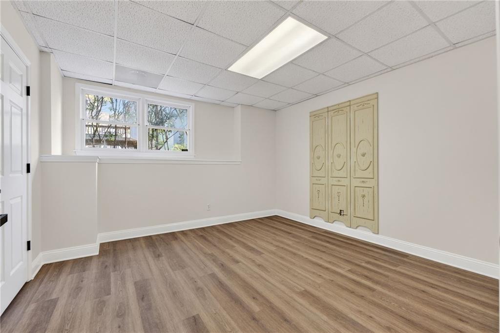 601 Cobblestone Lane Stone Mountain, GA 30087 - Photo 52 of 69 an empty room with wooden floor and windows