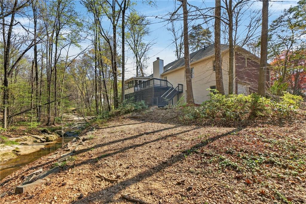 601 Cobblestone Lane Stone Mountain, GA 30087 - Photo 57 of 69 a backyard of a house with lots of green space