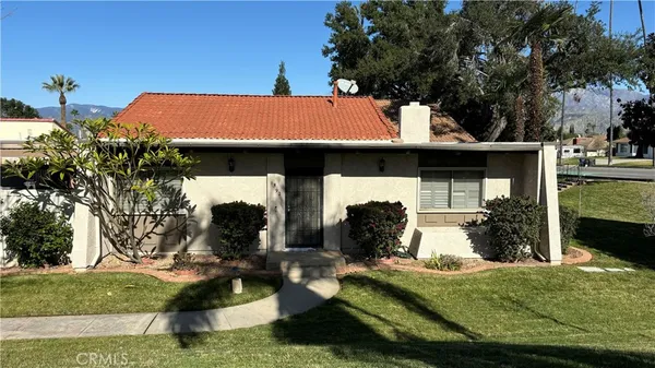 a view of a house with backyard porch and sitting area