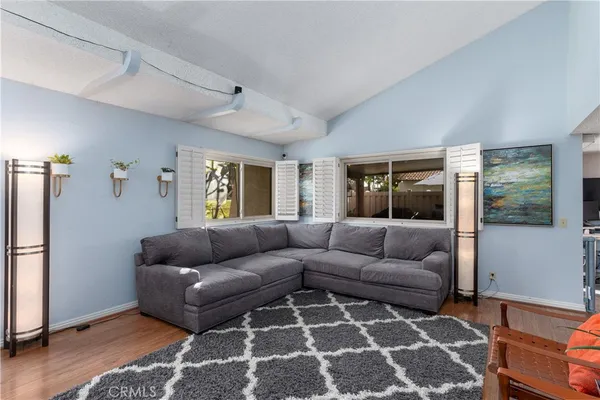 a living room with furniture and a rug
