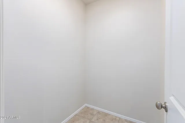 a view of a street with a yard and trees