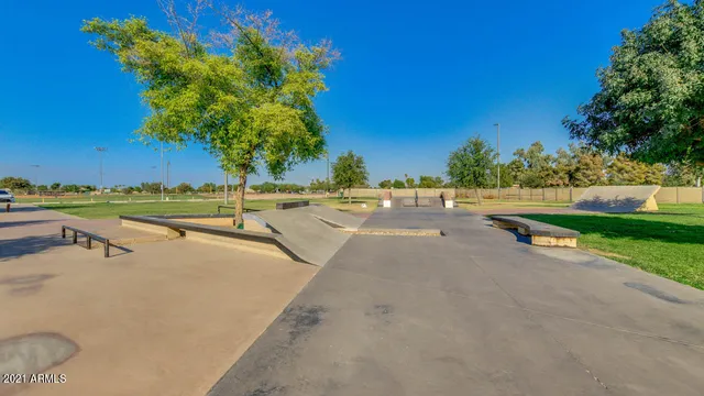 a backyard of a house with lots of green space and fountain