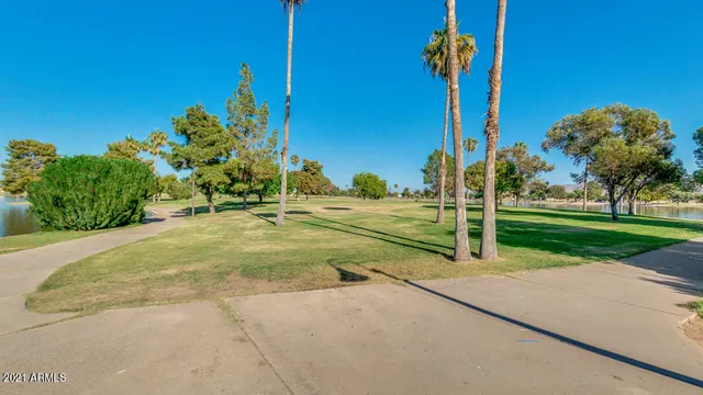 a view of a swimming pool and lounge chairs in the patio