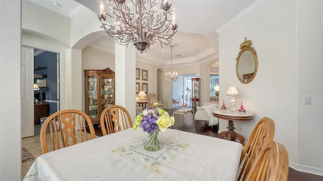 a living room with furniture a window and wooden floor