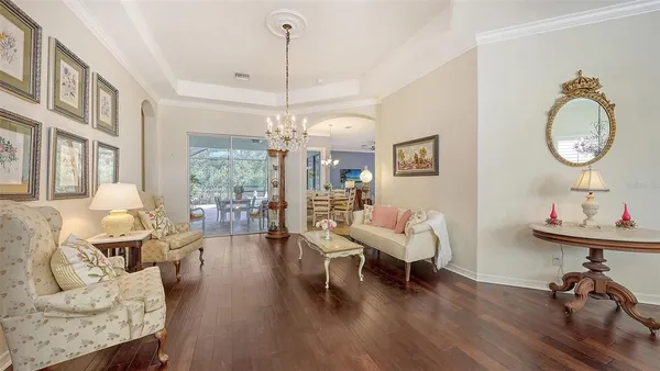 a living room with furniture and a chandelier