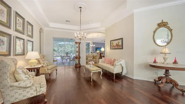 a living room with furniture and a chandelier