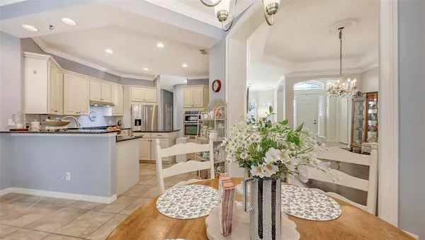 a kitchen with kitchen island granite countertop white cabinets and white appliances