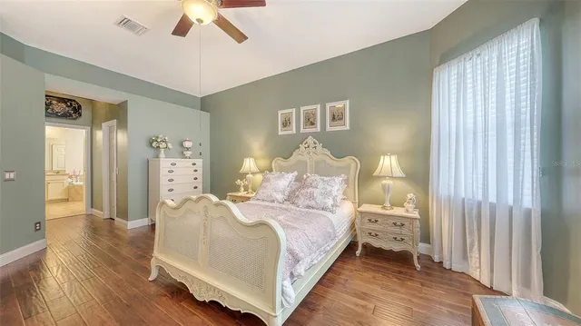 a bedroom with a large bed and a chandelier