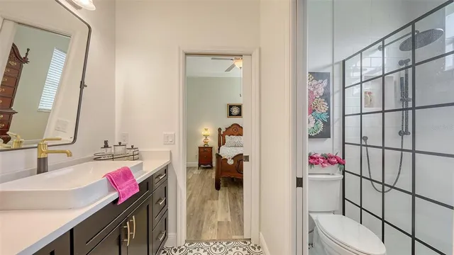 a bathroom with a shower sink and mirror