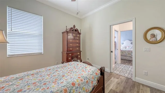 a backyard with table and chairs and potted plants