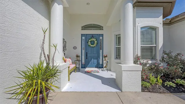 a view of a hallway with wooden floor and a livingroom