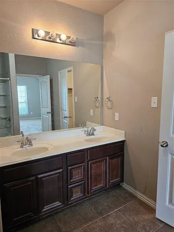 a bathroom with a double vanity sink and a mirror