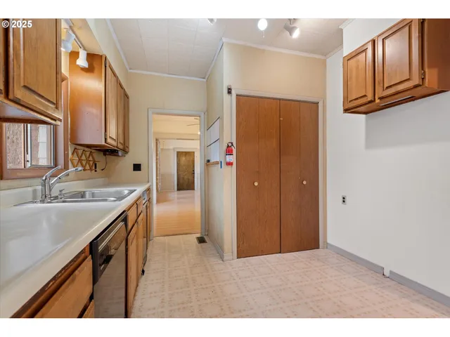 a living room with stainless steel appliances kitchen island granite countertop a stove and a microwave