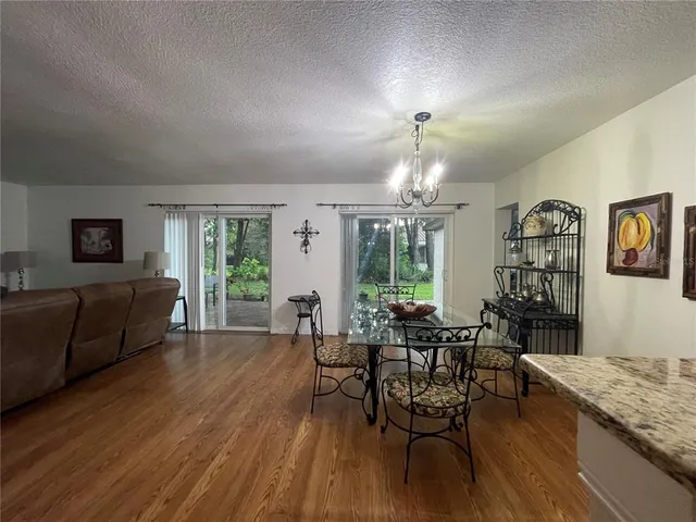 a view of a livingroom with furniture window and wooden floor