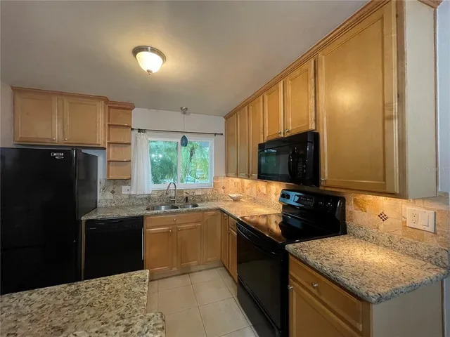a kitchen with granite countertop stainless steel appliances and sink
