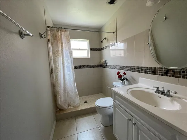 a bedroom with a bed lamp and window