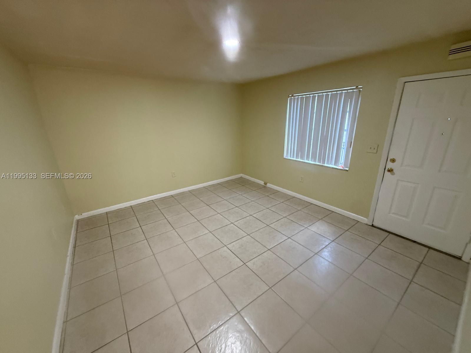17530 Northwest 68th Avenue, Unit C4013 Hialeah, FL 33015 - Photo 1 of 4 an empty room with windows