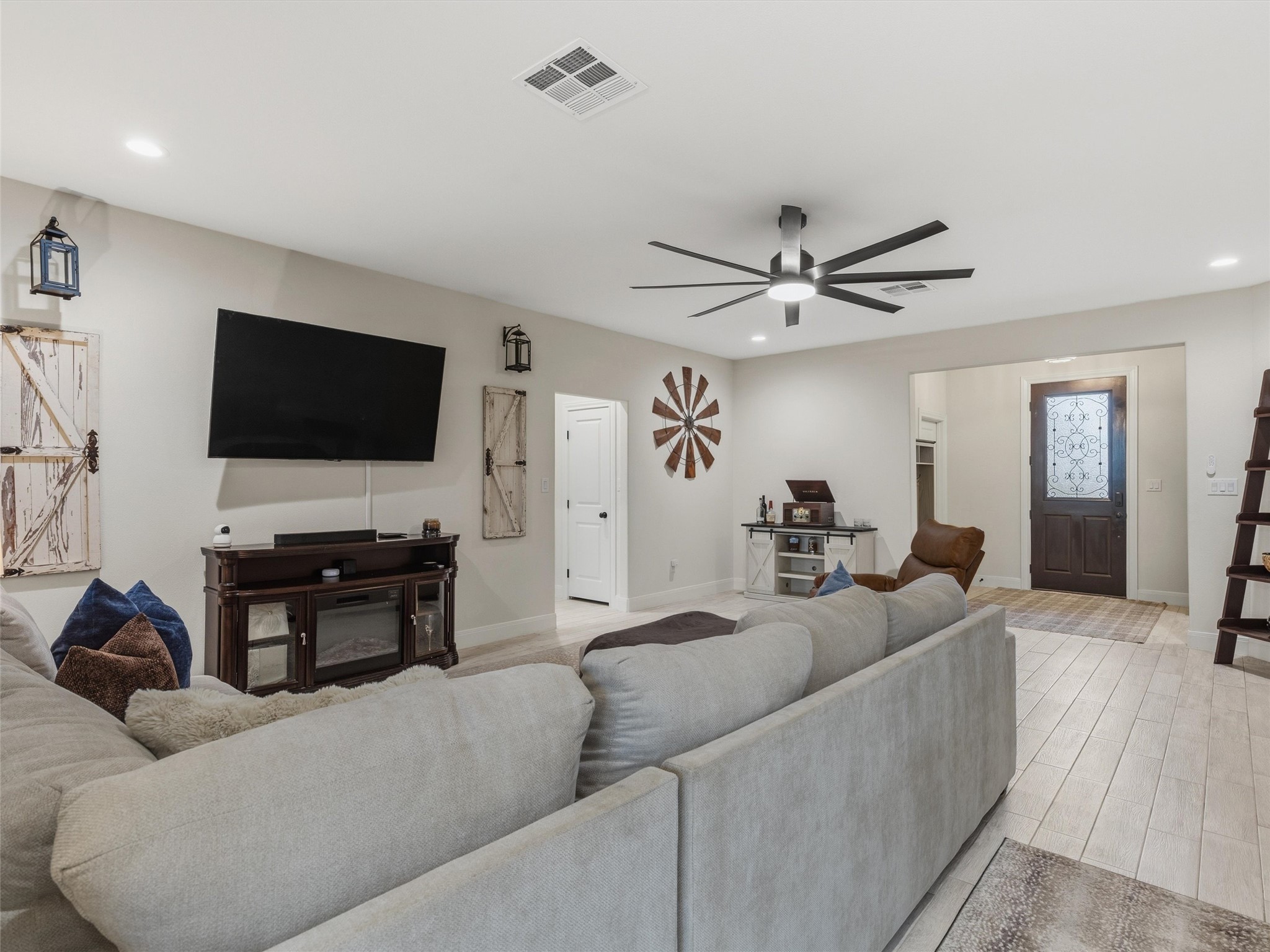 334 Webb Street Smithville, TX 78957 - Photo 5 of 36 a living room with furniture and a flat screen tv with wooden floor