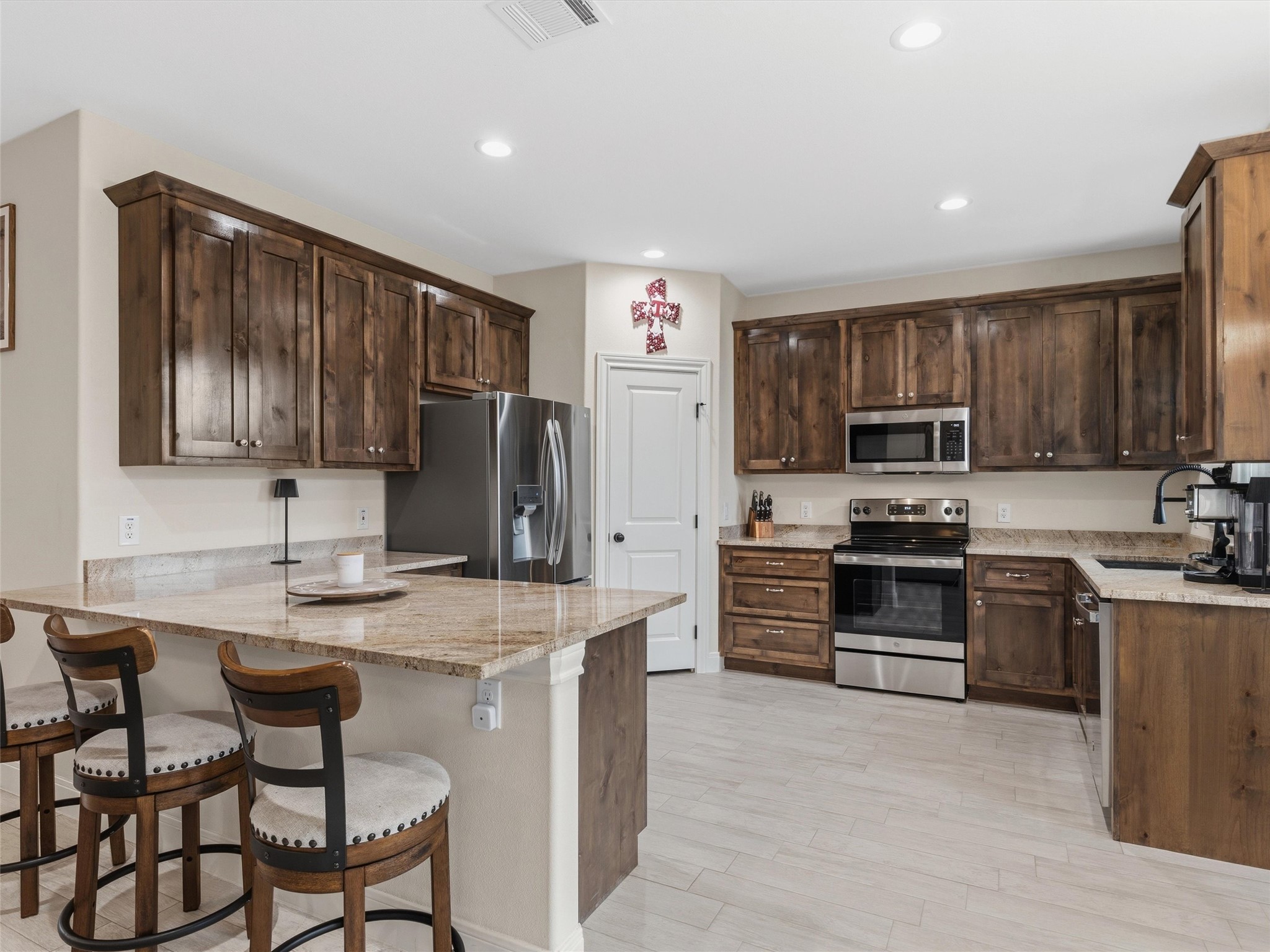 334 Webb Street Smithville, TX 78957 - Photo 8 of 36 a kitchen with stainless steel appliances granite countertop a stove top oven a refrigerator a sink and dishwasher