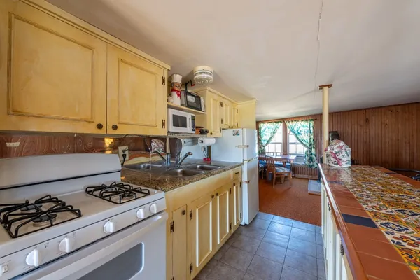 a kitchen with stainless steel appliances a stove a sink and a refrigerator
