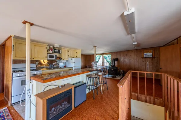 a kitchen with stainless steel appliances kitchen island granite countertop a sink and cabinets