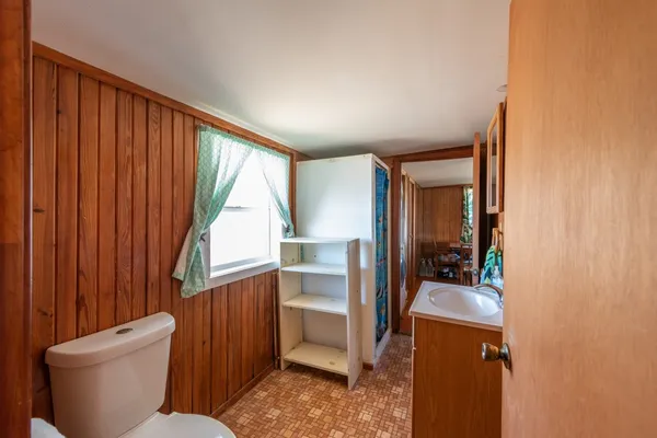 a bathroom with a sink toilet and shower curtain