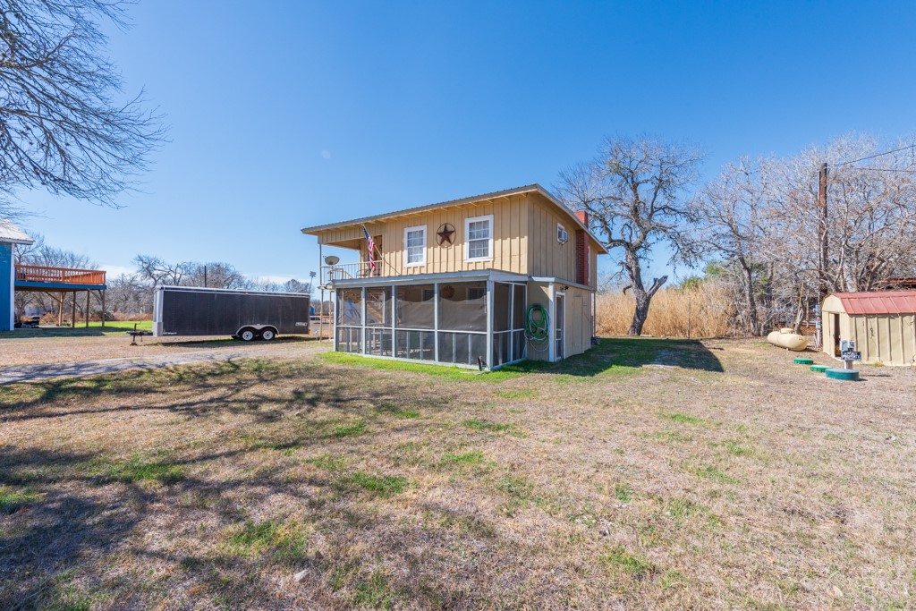 167 Buckeye Knoll Road George West, TX 78022 - Photo 2 of 40 a front view of a house with a yard