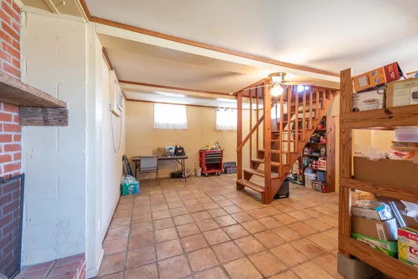 a view of hall way with furniture and a fireplace