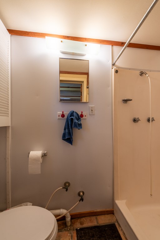 167 Buckeye Knoll Road George West, TX 78022 - Photo 23 of 40 a bathroom with a toilet and a shower